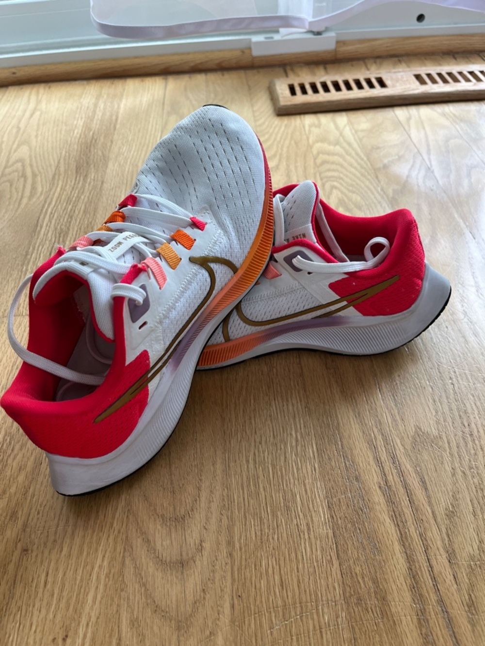 Nike Kids White Sneakers with Pink Collar and Gold Swoosh Accent